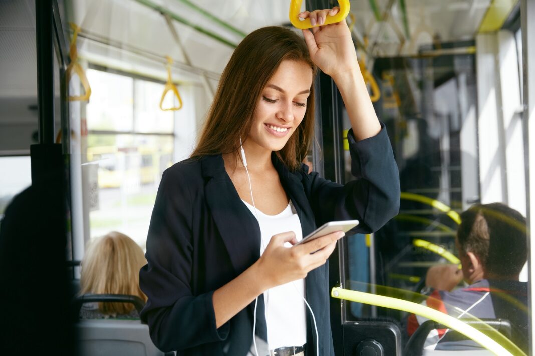 Woman,Listening,Music,On,Phone,Riding,In,Bus.,Portrait,Of