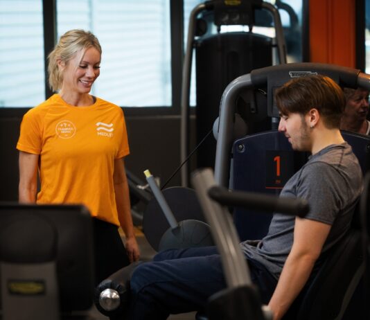 Medley satsar på onboarding – vill höja träningsfrekvensen och förbättra folkhälsan Kvinnlig personlig tränare på Medley instruerar man som styrketränar i maskin